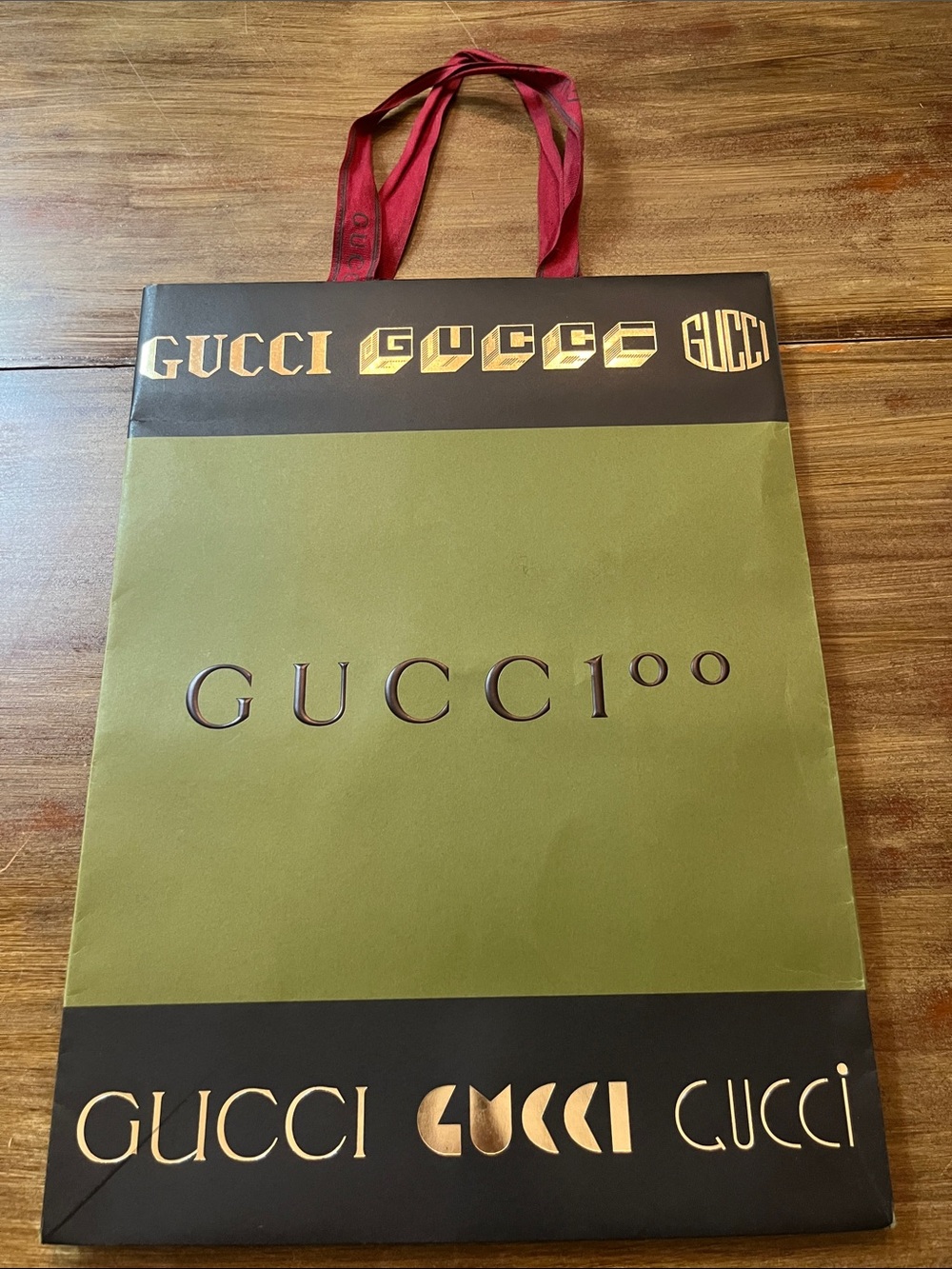1 limited-edition Gucci 100 anniversary paper shopping bag.